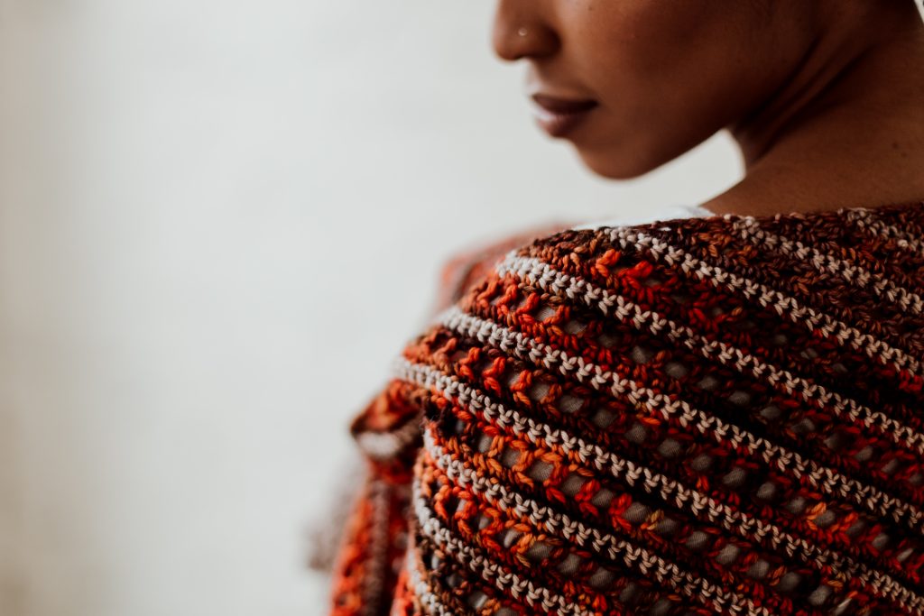Try the Bronwyn Shawl, a FREE crochet triangle shawl pattern from TLYCBlog.com. Explore the range of crochet techniques and stitches in this asymmetrical triangle wrap. Elevate the experience by using luxurious yarns like merino wool and baby alpaca. Find the FREE crochet pattern on TLYCBlog.com with links to helpful tutorial videos. | TLYCBlog.com
