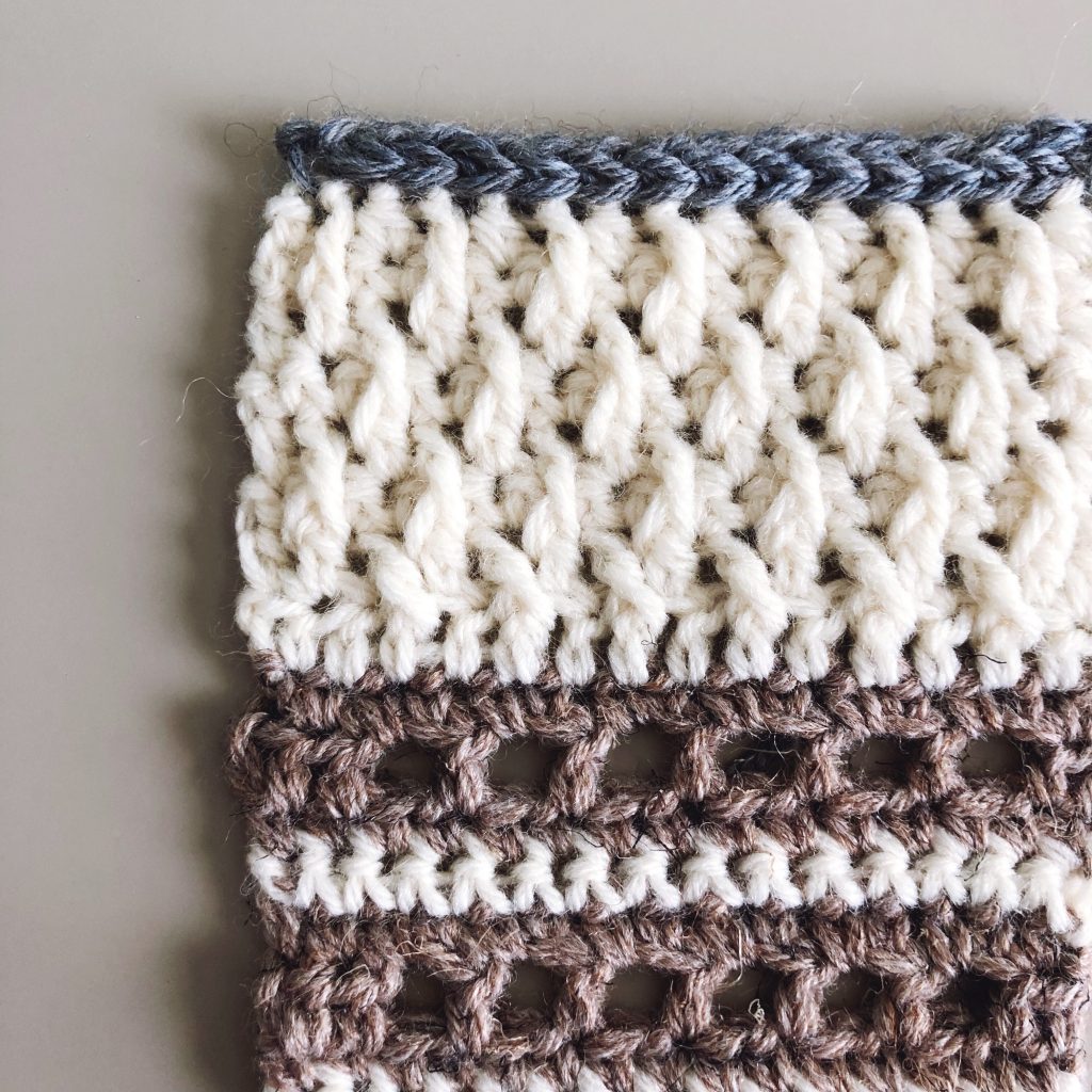 Try the Bronwyn Shawl, a FREE crochet triangle shawl pattern from TLYCBlog.com. Explore the range of crochet techniques and stitches in this asymmetrical triangle wrap. Elevate the experience by using luxurious yarns like merino wool and baby alpaca. Find the FREE crochet pattern on TLYCBlog.com with links to helpful tutorial videos. | TLYCBlog.com